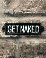 "Get Naked" Traditional Cast Iron Wall Sign mounted on abrick wall