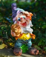 Angled view of mushroom picking garden gnome ornament
