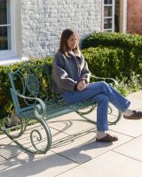 "Lyceum" Garden Rocking Bench Wrought Iron - Sage with lady sat on bench "Lyceum" Garden Rocking Bench Wrought Iron - Sage with lady sat on bench