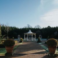 "Lady Leticia Dream Carousel" Bandstand Pavilion in Cream at the End of a Garden - Manor By The Lake "Lady Leticia Dream Carousel" Bandstand Pavilion in Cream at the End of a Garden - Manor By The Lake