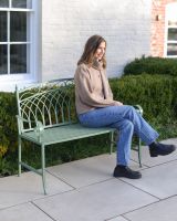 "Monet" Two Seater Wrought Iron Garden Bench - Sage lady sat on bench