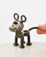 "Nuts" Standing Puppy Upcycled Metal Home Ornament with hand in shot for scale