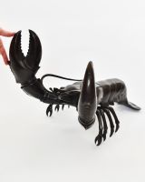 "Obsidian Tide" Lobster sculpture in Cast Brass with hand in shot for scale