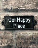 "Our Happy Place" Traditional Cast Iron Wall Sign mounted on a brick wall