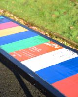 "Prism" Upcycled Oil Drum Garden Bench close up of colours and oil drum print along length of bench