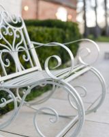 "Province" Wrought Iron Cream Garden Rocking Chair close up of legs "Province" Wrought Iron Cream Garden Rocking Chair close up of legs