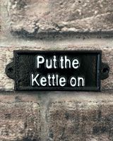 "Put the Kettle On" Traditional Cast Iron Wall Sign mounted on brick wall