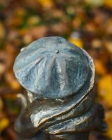 "Rain or Shine" Male Resin Garden Sculpture Brass and Verdigris Finish close up of hat