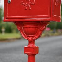 Close-Up of Detailing on “Saffron Blossom” Red Suffolk Post Box with Stand Close-Up of Detailing on “Saffron Blossom” Red Suffolk Post Box with Stand
