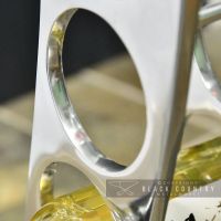 Close-up of the Aluminium Finish on the Curved Wine and Bottle Holder