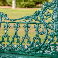Ornate Detailing on the Back of the Green Cast Iron Gothic Garden Bench Ornate Detailing on the Back of the Green Cast Iron Gothic Garden Bench