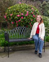 "Twilight" Wrought Iron Arched Garden Bench with Lady Sat on Bench for Scale