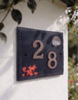A "Helmsford House" Hedgehog Slate House Number Sign with a Number 28 Fixed to it Mounted on a White Cottage Wall - Digital Illustration