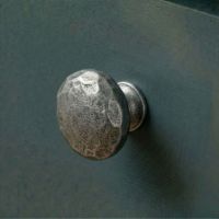 A 38mm Hammered Cast Iron Cabinet Knob Mounted on a Contemporary Blue Kitchen Cupboard - Digital Illustration 
