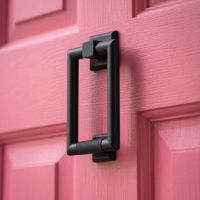 A Candy Pink Front Door with a Matt Black Modern Knurled Rectangular Door Knocker Mounted on it - Digital Illustration