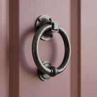 A Close up Image of the Slim Antique Pewter Ring Door Knocker on a Pink Door - Digital Illustration A Close up Image of the Slim Antique Pewter Ring Door Knocker on a Pink Door - Digital Illustration