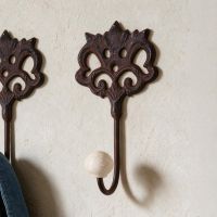 A Close up of "Lady Elinor" Cast Iron Hook Pictured on a Sunny Interior Wall - Digital Illustration A Close up of "Lady Elinor" Cast Iron Hook Pictured on a Sunny Interior Wall - Digital Illustration