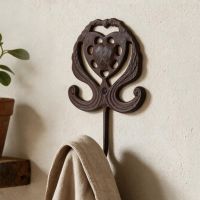 A Close up of a "Lady Marguerite" Cast Iron Hook on a Textured Interior Wall - Digital Illustration A Close up of a "Lady Marguerite" Cast Iron Hook on a Textured Interior Wall - Digital Illustration