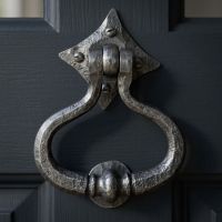 A Close up of the "Capulet" Pewter Shakespeare Door Knocker on a Blue Front Door With Windows - Digital Illustration A Close up of the "Capulet" Pewter Shakespeare Door Knocker on a Blue Front Door With Windows - Digital Illustration