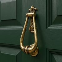 A Close up of the Aged Brass Traditional Loop Handle Door Knocker on the Front of a Green Door - Digital Illustration A Close up of the Aged Brass Traditional Loop Handle Door Knocker on the Front of a Green Door - Digital Illustration