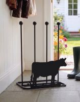 A Dairy Cow Double Boot Rack Placed at the Entrance of a Open Cottage Door - Digital Illustration