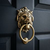 A Navy Front Door to a Period Property with an Aged Brass Traditional Lion"s Head Front Door Knocker Mounted on to it - Digital Illustration A Navy Front Door to a Period Property with an Aged Brass Traditional Lion"s Head Front Door Knocker Mounted on to it - Digital Illustration