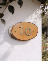 A Number 10 Natural Hard Wood Rustic House Number Sign Mounted on a Sunny White Garden Wall - Digital Illustration A Number 10 Natural Hard Wood Rustic House Number Sign Mounted on a Sunny White Garden Wall - Digital Illustration