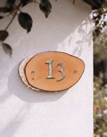 A Number 13 Natural Hard Wood Rustic House Number Sign Mounted on a White Cottage Garden Wall - Digital Illustration