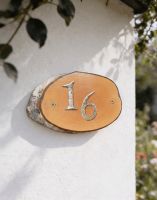 A Number 16 Natural Hard Wood Rustic House Number Sign Mounted on a Cream Coloured Cottage Wall - Digital Illustration A Number 16 Natural Hard Wood Rustic House Number Sign Mounted on a Cream Coloured Cottage Wall - Digital Illustration
