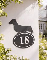 A Number 18 Dachshund Iron House Number Sign Mounted on a White Cottage Garden Wall - Digital Illustration A Number 18 Dachshund Iron House Number Sign Mounted on a White Cottage Garden Wall - Digital Illustration