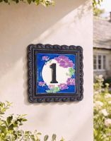 A Number 1 "Moonlit Lilac" Small House Number Sign Mounted on a Sunny white Cottage Wall - Digital Illustration 