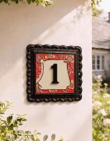 A Number 1 "Scarlett Blooms" Small Iron & Tile House Number Sign Mounted on a Cream Coloured Cottage wall - Digital Illustration