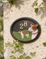 A Number 28 Hand Painted Jack Russell House Sign Mounted on a Cream Coloured Cottage Wall - Digital Illustration A Number 28 Hand Painted Jack Russell House Sign Mounted on a Cream Coloured Cottage Wall - Digital Illustration