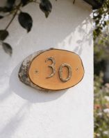 A Number 30 Natural Hard Wood Rustic House Number Sign Mounted on a Sunny White Cottage Wall - Digital Illustration A Number 30 Natural Hard Wood Rustic House Number Sign Mounted on a Sunny White Cottage Wall - Digital Illustration