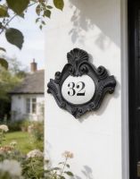 A Number 32 Renaissance Period Style House Plaque Mounted on a Cottage Garden Wall - Digital Illustration 