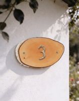 A Number 3 Natural Hard Wood Rustic House Number Sign Mounted on a Sunny White Housefront - Digital Illustration