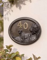 A Number 40 "Bentley" Bull Mastiff Dog House Sign Mounted on a Cream Coloured Sunny Cottage Wall - Digital Illustration A Number 40 "Bentley" Bull Mastiff Dog House Sign Mounted on a Cream Coloured Sunny Cottage Wall - Digital Illustration