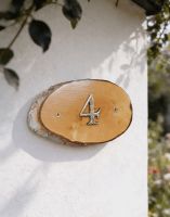 A Number 4 Natural Hard Wood Rustic House Number Sign Mounted on a White Coloured Cottage Garden Wall - Digital Illustration 