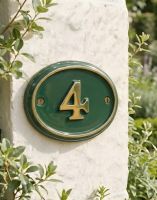 A Number 4 Polished Brass & Green Cast Oval House Number Sign On a Cream Coloured Cottage Wall - Digital Illustration 