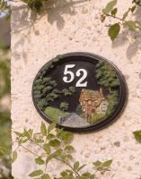 A Number 52 "Brushford Hill Cottage" Hand Painted Countryside House Sign Mounted on a Sunny Cream Coloured Cottage - Digital Illustration A Number 52 "Brushford Hill Cottage" Hand Painted Countryside House Sign Mounted on a Sunny Cream Coloured Cottage - Digital Illustration