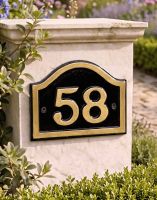 A Number 58 Black & Gold Painted Arched House Number Sign Mounted on a Wall next to an Entrance Driveway - Digital Illustration