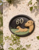 A Number 60 Hand Painted Rhodesian Ridgeback House Sign Mounted on a Textured Cottage Garden Wall - Digital Illustration A Number 60 Hand Painted Rhodesian Ridgeback House Sign Mounted on a Textured Cottage Garden Wall - Digital Illustration