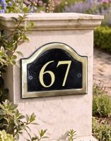 A Number 67 in Vinyl on a Black & Brass Arched House Number Sign Mounted on a Driveway Entrance Wall - Digital Illustration - Digital Illustration 