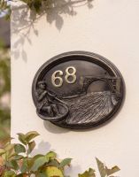 A Number 68 "Rivervalley Gorge" Coracle Sailor House Sign Mounted on a Cream Coloured Sunny Cottage Wall - Digital Illustration