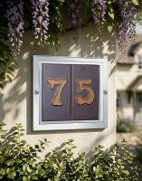 A Number 75 Double Plain Tile Number Frame Mounted on a Flowery Cottage Wall - Digital Illustration 