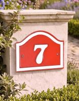 A Number 7 Red and White Painted Arched House Number Sign Mounted on an Entrance Driveway Wall - Digital Illustration