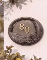 A Number 80 "Docklow Valley" Fisherman House Number Sign in a Bronze Finish Mounted on a Cream Coloured Cottage Wall - Digital Illustration 