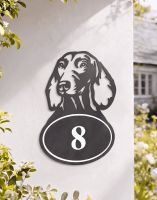 A Number 8 Dachshund Iron House Number Sign Mounted on a White Coloured Exterior Property Wall - Digital Illustration