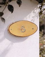 A Number 8 Natural Hard Wood Rustic House Number Sign Mounted on a Sunny White Cottage Wall - Digital Illustration A Number 8 Natural Hard Wood Rustic House Number Sign Mounted on a Sunny White Cottage Wall - Digital Illustration