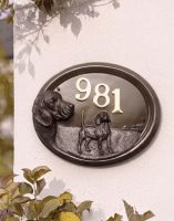 A Number 981 "Tucker" Beagle House Number Sign in a Bronze Finish Mounted on a Cream Coloured Cottage Wall - Digital Illustration